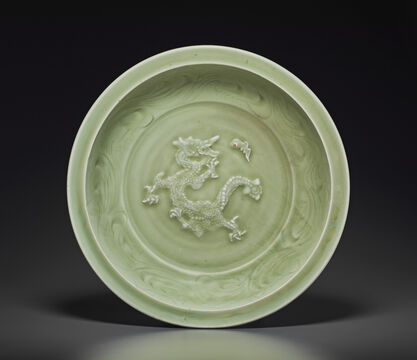 A Rare Large Molded And Carved Longquan Celadon `Dragon’ Dish